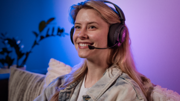 A person wearing the SteelSeries Arctis Nova 5 wireless headset.
