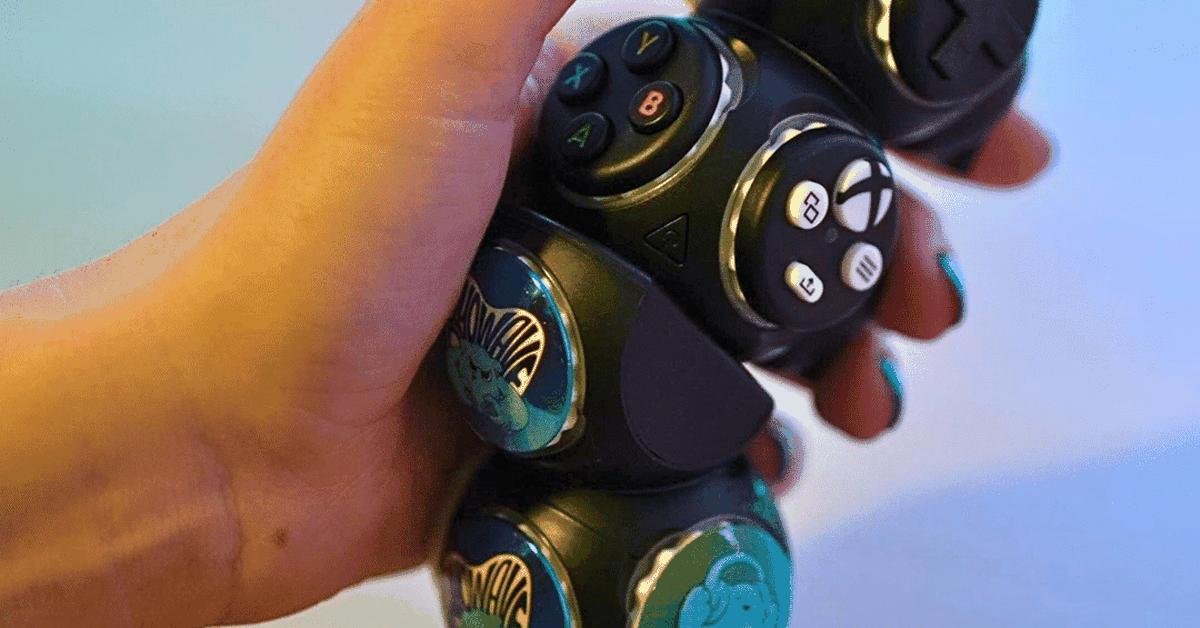 A hand holding the Proteus Controller, which consists of modular cubes.