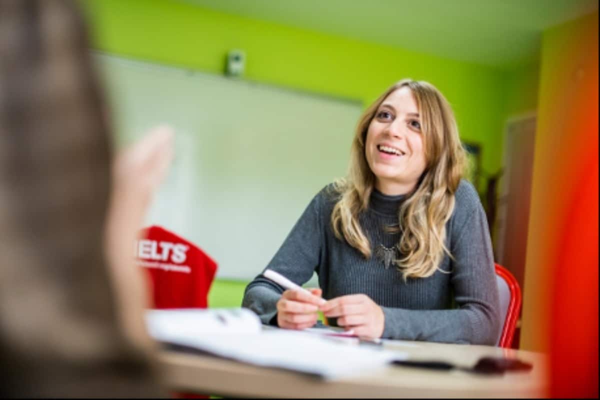 A woman is with an examiner from the IELTS test.