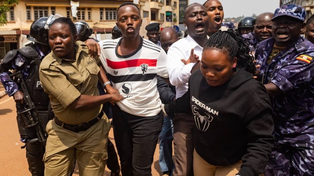 Members of the Uganda Police arrest protesters marching to parliament during a planned anti-corruption demonstration in Kampala. Police were out in force on the empty streets of the Ugandan capital Kampala ahead of a planned anti-corruption rally that has been banned by the authorities. (Badru Katumba/AFP)