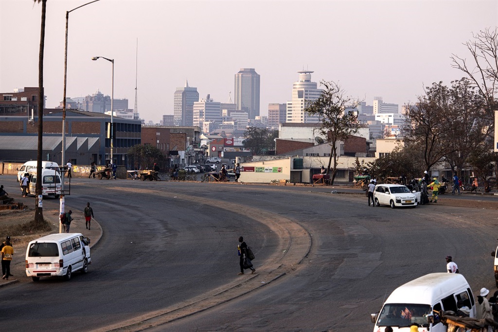 
A man walks on a main road in Harare in August 2023. Zimbabwe is hosting the 44th ordinary SADC summit in Harare next month. (JOHN WESSELS / AFP)