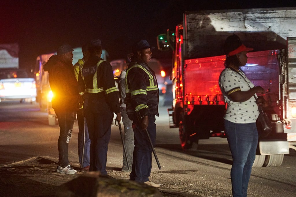 Zimbabwean police dispersing people at an intersection in Chitungwiza in August 2023, to prevent what they considered an illegal gathering. (Zinyange Auntony / AFP)