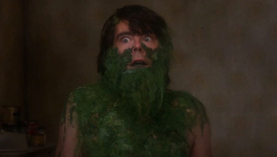 Stephen King as Jordy Verrill with face, chest and shoulders covered with plants in Creepshow