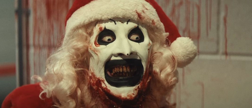 Close-up of Art the Clown bloodied in Santa hat and wig in Terrifier 3