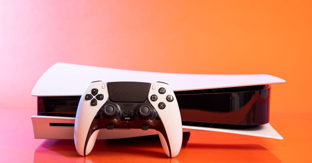 A Sony DualSense Edge controller resting on a PlayStation 5 with an orange background.