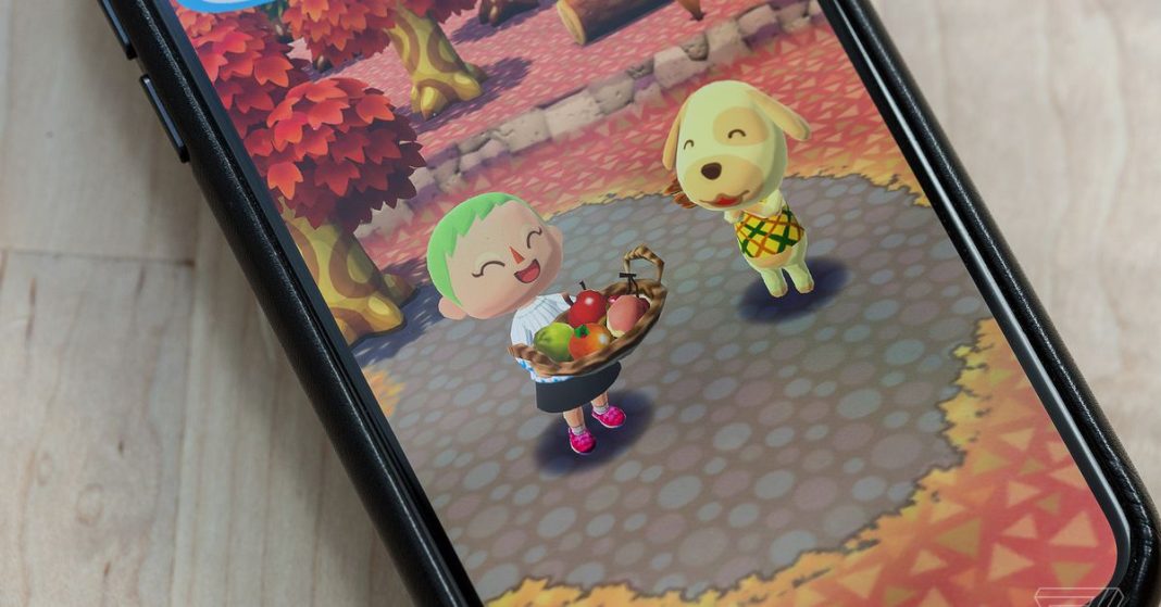 A phone on a table playing Animal Crossing: Pocket Camp.