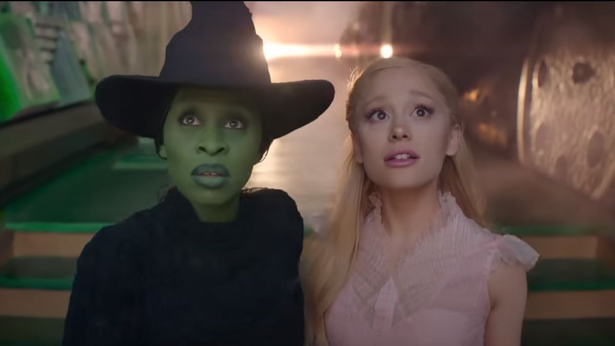 From left to right, Cynthia Erivo as Elphaba and Ariana Grande as Glinda in Wicked, looking in awe. 