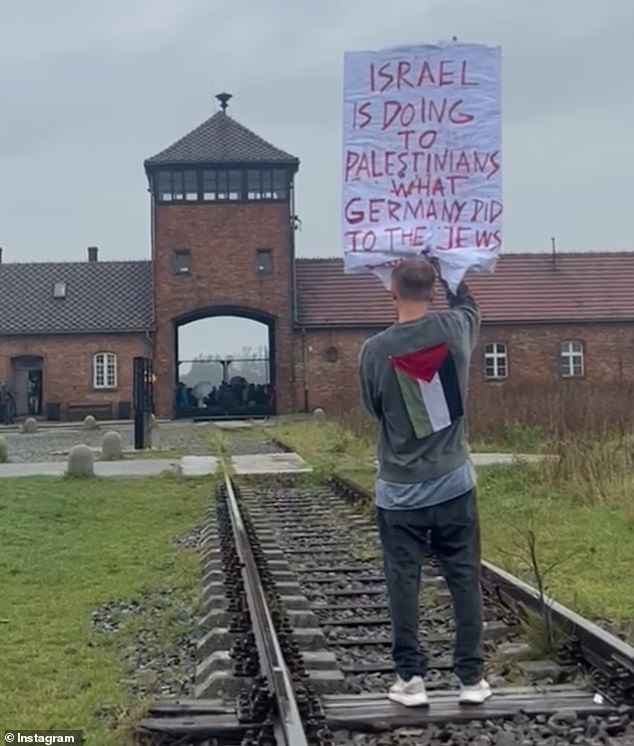 Un artista polaco ha provocado indignación después de pararse frente al antiguo campo de exterminio nazi de Auschwitz con un cartel que decía: 