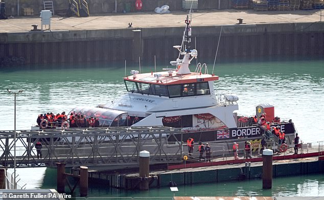 Más de 600 inmigrantes cruzaron el Canal sólo un día después de que un bebé muriera trágicamente mientras realizaba el arriesgado viaje (en la foto: funcionarios de la Fuerza Fronteriza Británica escoltan a los inmigrantes hasta los muelles de Dover en Kent, Reino Unido, el 18 de octubre).