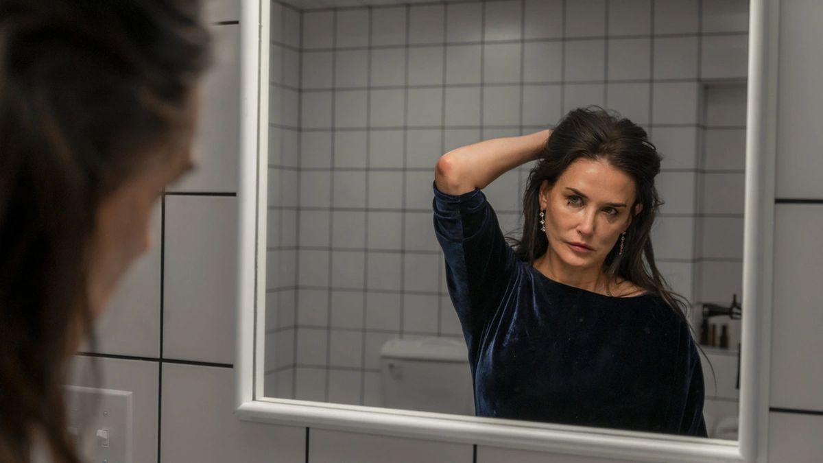 Demi Moore in front of a mirror in The Substance