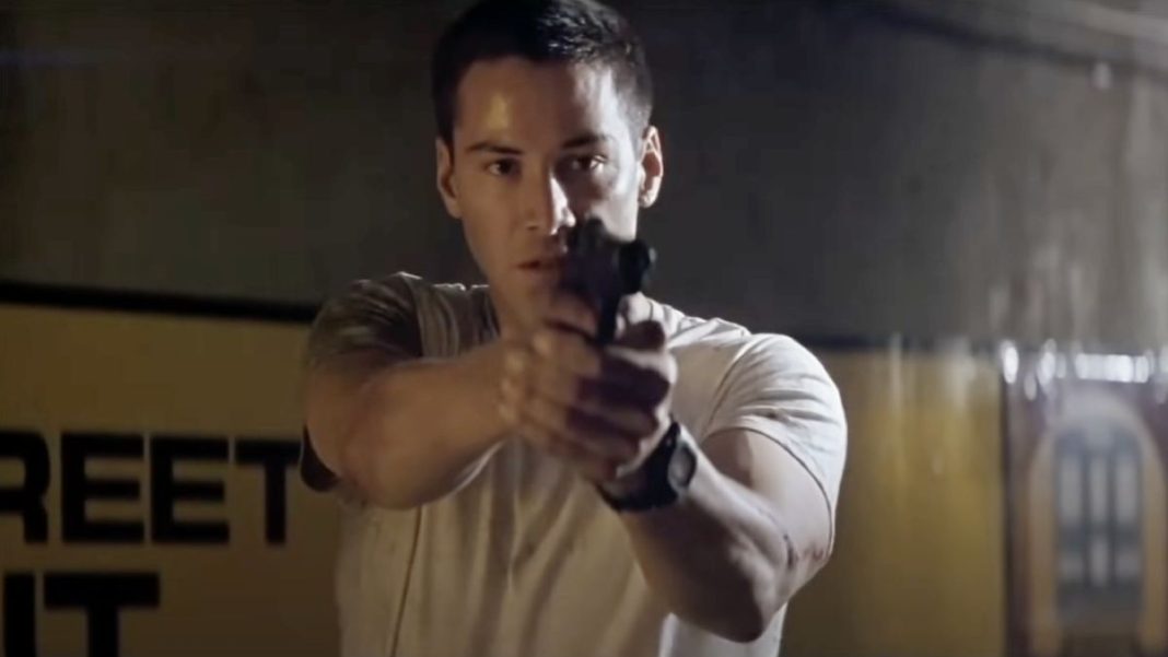 Keanu Reeves as Jack pointing his gun in Speed.