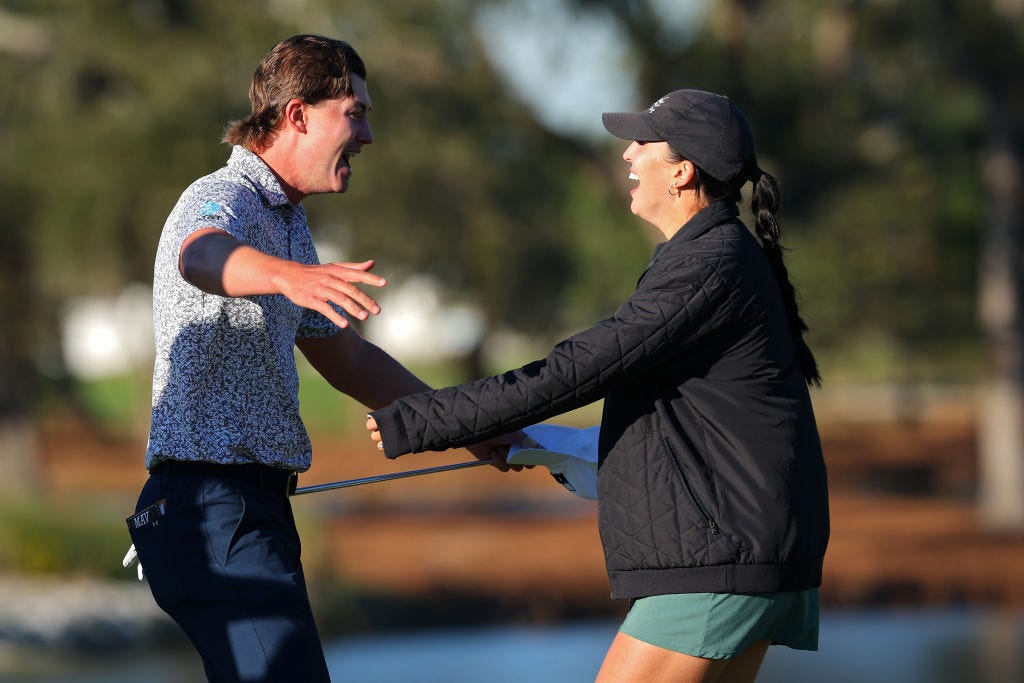 Maverick McNealy celebrates his victory at the RSM Classic on Sunday with his wife Maya Daniels. McNealy birdied the last hole at the Sea Island Golf Club Seaside Course to win by one shot.