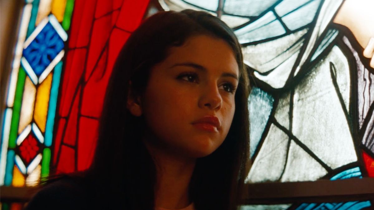 Selena Gomez looking lost, cathedral window backlighting her, in Spring Breakers (2012). 