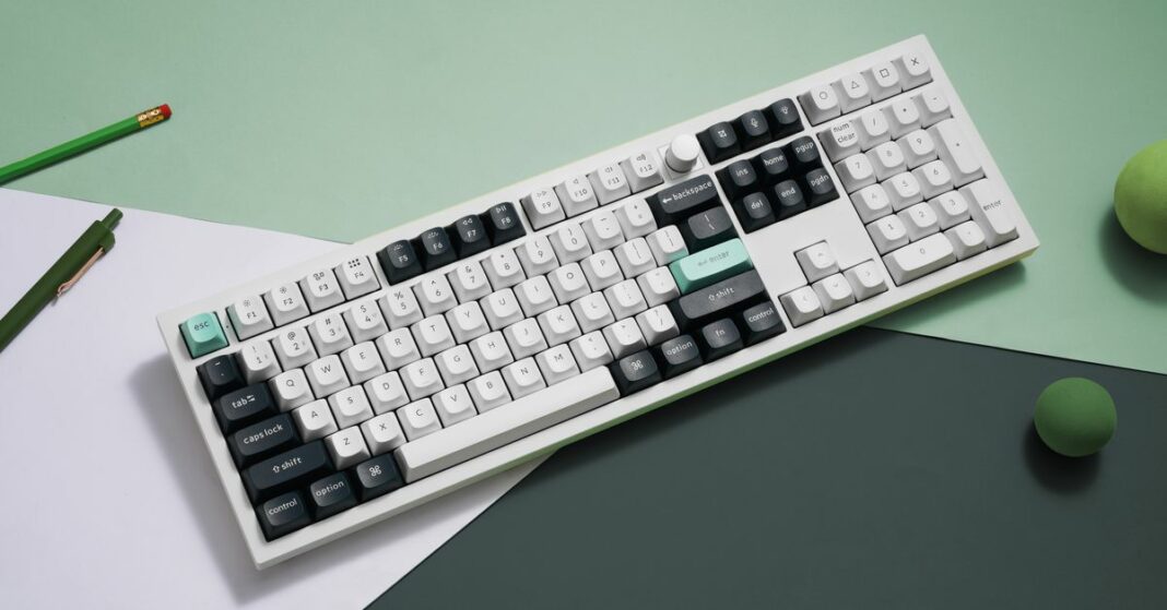 The Keychron Q6 HE&nbsp;in white against a green and white background.