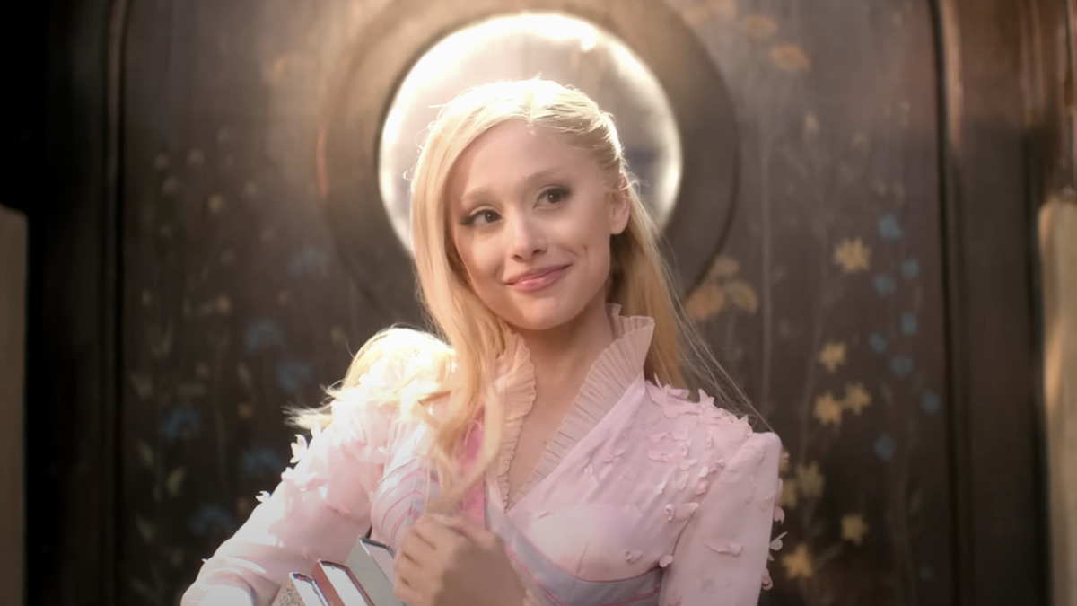 Ariana Grande smiling as Glinda in Wicked What Is This Feeling number 