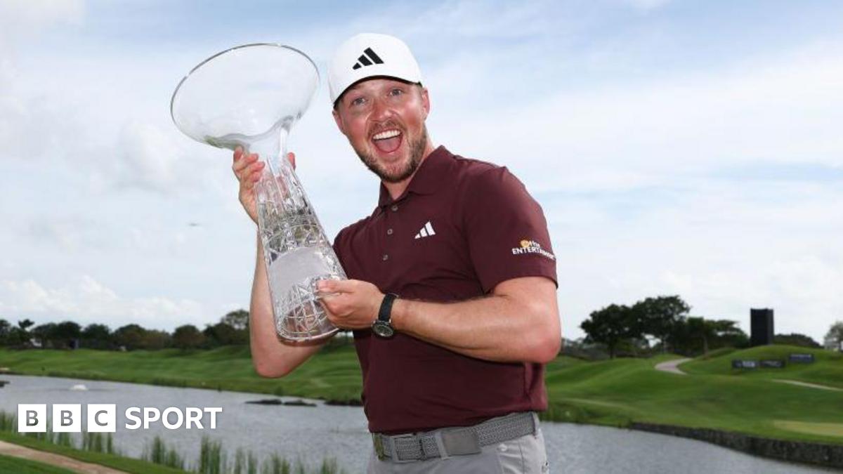 Richard Mansell celebrates with the Singapore Classic trophy