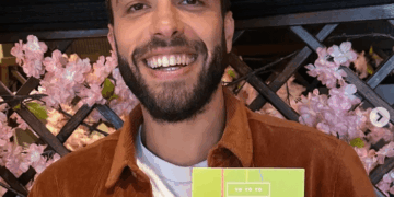 Hombre sosteniendo una tarjeta temática de yo-yo.