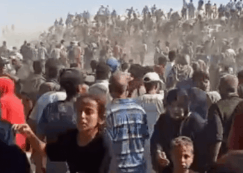 Gran multitud de personas se reunieron, muchas a caballo o camellos en el fondo.