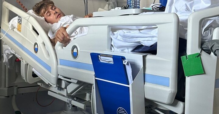 Hombre acostado en una cama de hospital.