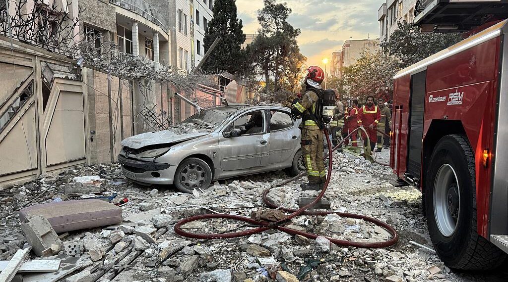Los primeros respondedores se reúnen fuera de un edificio que fue golpeado por una huelga israelí en Teherán, Irán, el 13 de junio de 2025. (Meghdad Madad/AFP a través de Getty Images)