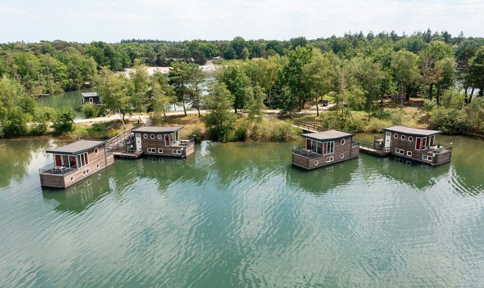 Vista aérea de cuatro casas flotantes en un lago.