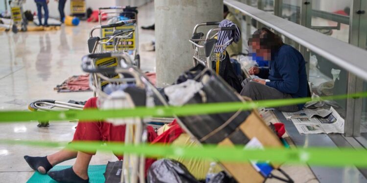 Personas sin hogar que duermen en una terminal del aeropuerto.