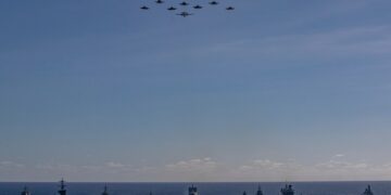 Vista aérea de múltiples buques de guerra navegando en formación.