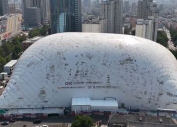 Vista aérea de una gran cúpula inflable que cubre un sitio de construcción en una ciudad.