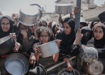 Los palestinos, incluidos los niños, se alinean para recibir comida en la ciudad de Gaza.