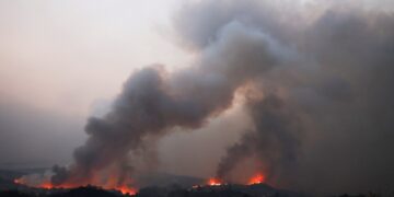 El humo de los incendios forestales hunda sobre un paisaje.