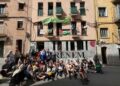 Los miembros de PAHC se sientan fuera del edificio recuperado donde Pablo y Nadia viven en Manresa, Cataluña, el 5 de mayo de 2024, para celebrar el primer aniversario de la sentadilla.