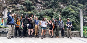 Un grupo de turistas saluda mientras se va a pie debido a una protesta en Machu Picchu Pueblo.