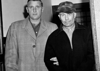 El sheriff del condado de Waushara, Art Schley, escorts Edward Gein al Hospital Central del Estado.