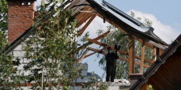 Soldado polaco inspeccionando una casa dañada.