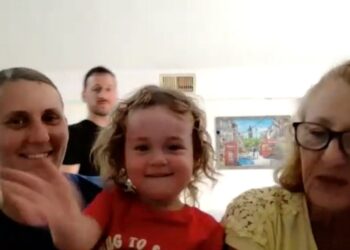 Una mujer con una camisa azul que saluda, una niña con una camisa roja sonriendo, un hombre y una mujer con gafas.