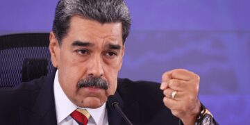 Nicolás Maduro hablando en una conferencia de prensa, con un puño cerrado.