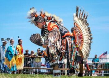 Jonathan Baca del norte de Colorado, en el centro, bailando con otros nativos americanos durante el 43º Paumanauke Pow Wow en Tanner Park en Copiague, Nueva York, el 9 de agosto de 2025.