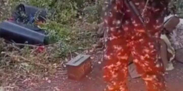 Aiden Minnis quemando un pasaporte del Reino Unido en el suelo.