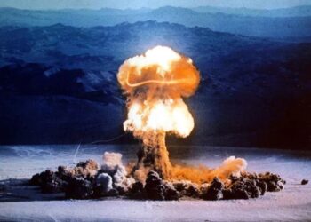 Un collage de imágenes que contiene 1 imágenes. La imagen 1 muestra la explosión de una bomba atómica en un paisaje desértico.