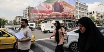Los iraníes pasan junto a un gran cartel que representa al líder iraní Ayatollah Mojtaba Khamenei en una calle de Teherán el 20 de abril de 2026. (Atta Kenare/AFP vía Getty Images)